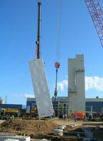 Liquefier (NLU) cold box approaches vertical.  Note that smaller crane is lift crane, large crane is tailing crane.